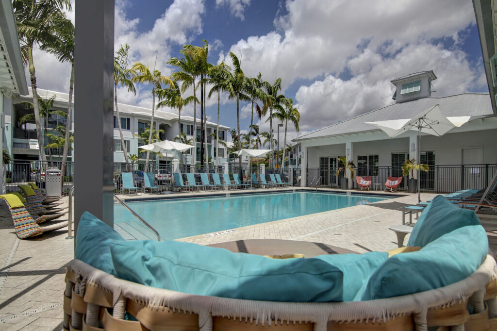 Pool deck with shaded day beds and deck seating