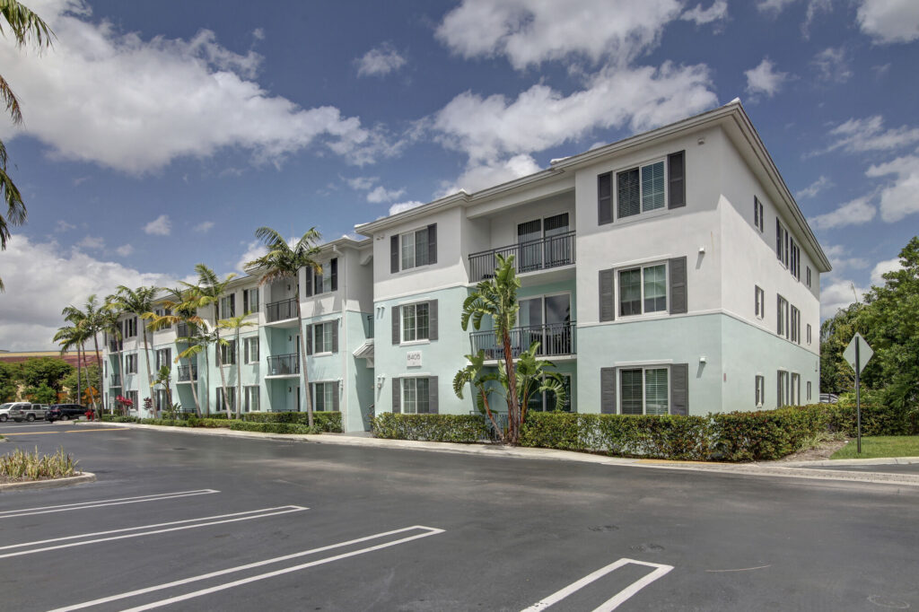 Building exterior with balconies and palm trees