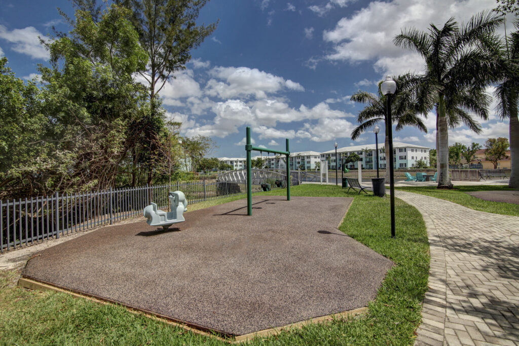 Playground with large trees and walking path