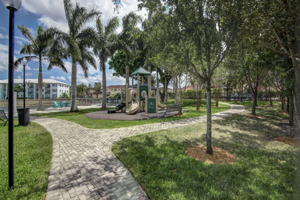 Playground with large trees and walking path